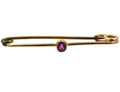 Lot A yellow metal and ruby brooch
