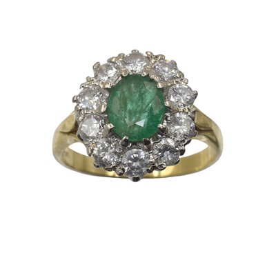 Lot 12 - An 18ct gold, emerald and diamond cluster ring