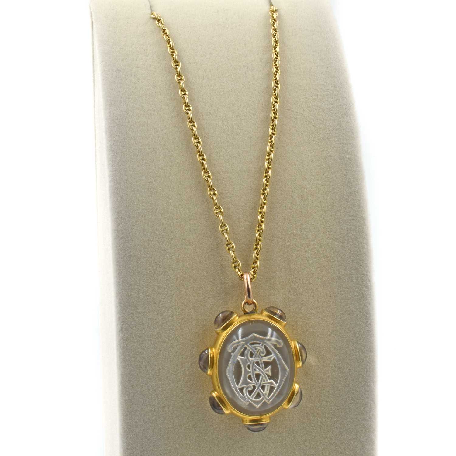 Lot A late Victorian reverse intaglio rock crystal pendant and 15ct gold chain