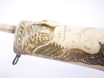 Lot 690 - Bone powder flask carved with a cherub holding...