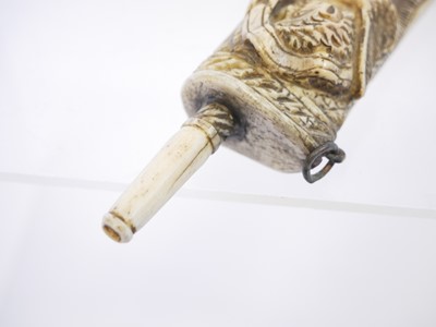 Lot 690 - Bone powder flask carved with a cherub holding...