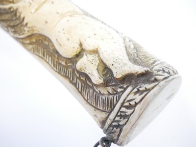 Lot 690 - Bone powder flask carved with a cherub holding...