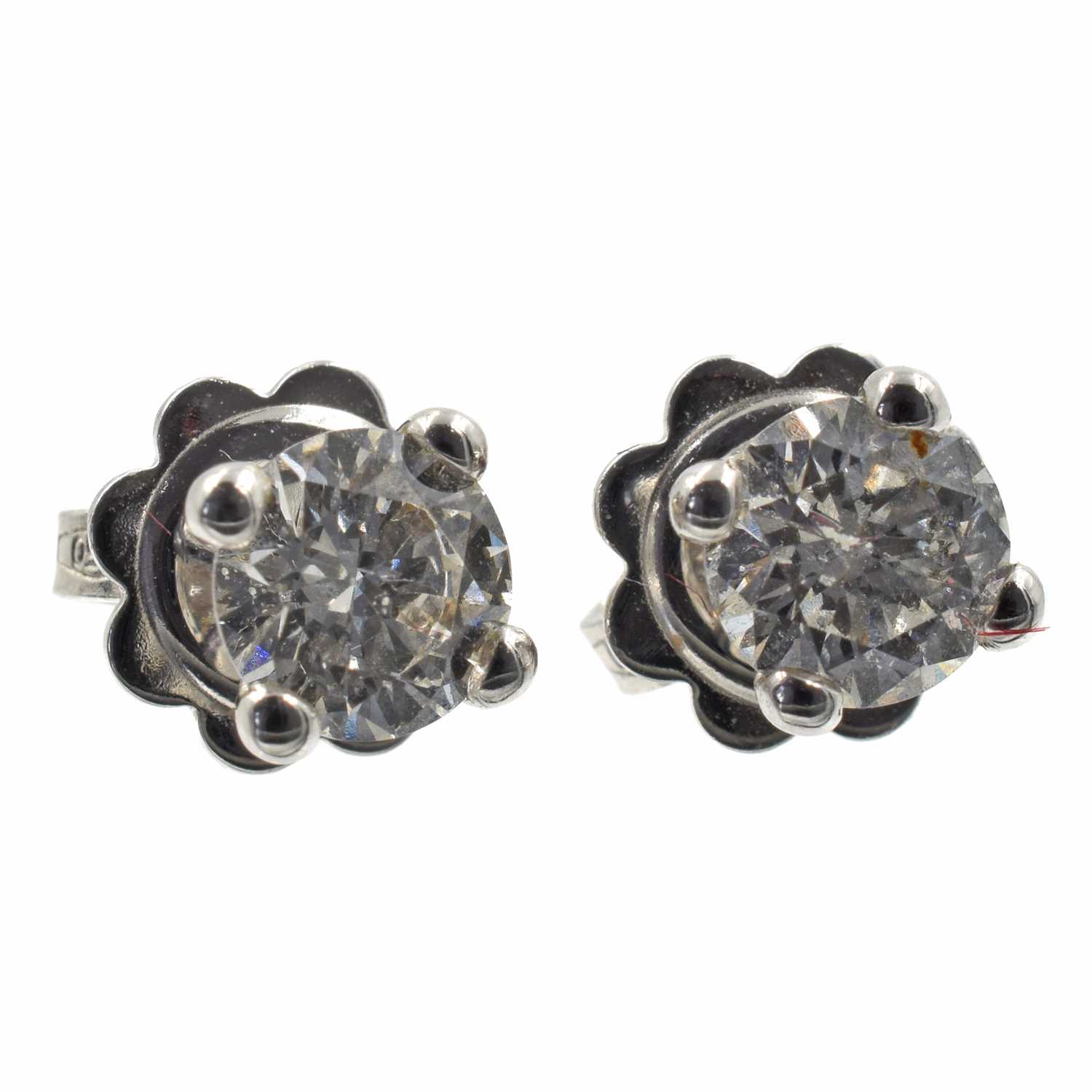 Lot A pair of 18ct white gold diamond stud earrings