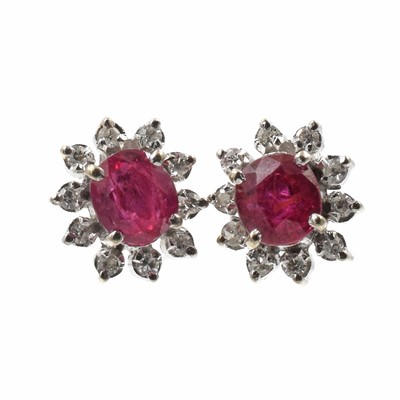 Lot 190 - A pair of white metal ruby and diamond cluster earrings