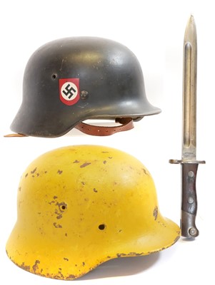 Lot Two German helmets, one with liner rebadged,...