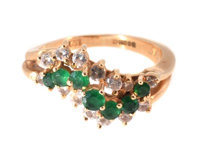 Lot 98 - An 18ct yellow gold diamond and emerald ring