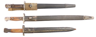 Lot Three Lee Enfield rifle bayonets and scabbards,...