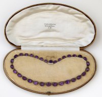 Lot 379 - Amethyst cased necklace.