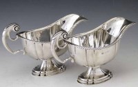 Lot 231 - Pair of silver cream jugs.