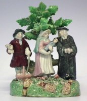 Lot 135 - Staffordshire Tythe Pig group, typically modelled