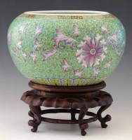 Lot 308 - Chinese green ground jardiniere on wood stand.