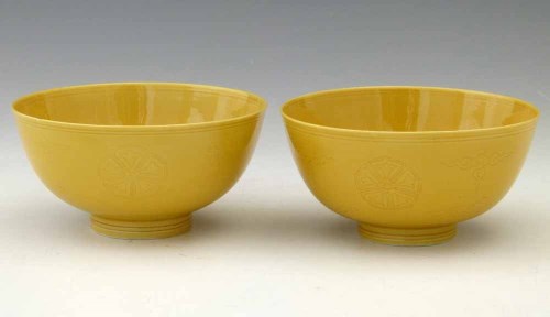 Lot 322 - Pair of incised yellow glazed bowls.