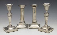 Lot 411 - Two pairs of silver candlesticks.