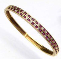 Lot 305 - 375 gold ruby and diamond bangle.
