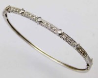 Lot 308 - 14k gold and diamond bangle.