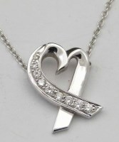 Lot 337 - Tiffany 750 and diamond pendant on chain