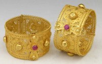 Lot 344 - Pair of Indian filigree yellow metal hinged