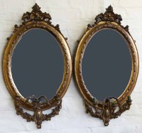 Lot 648 - Pair of oval gilt framed girandole wall mirrors