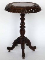 Lot 686 - A Burmese carved hardwood tripod table