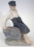 Lot 232 - Royal Copenhagen figure of a boy sat upon a rock