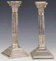 Lot 318 - Pair of silver corinthian column candlesticks.