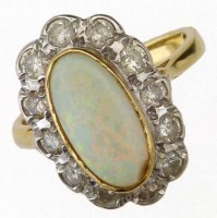 Lot 414 - Oval opal and diamond ring.
