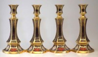 Lot 89 - Four Caverswall candlesticks.