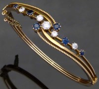 Lot 314 - Diamond and sapphire yellow metal bangle