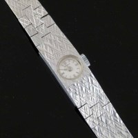 Lot 358 - White gold lady's watch by Bulova.