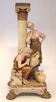 Lot 247 - Royal Dux figures at a column group.