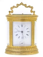 Lot 645 - French oval carraige clock alarm.