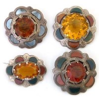 Lot 270 - Four silver cloak brooches each set with a
