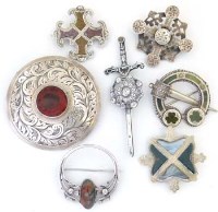Lot 273 - Silver sword and targe brooch and five others set