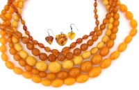 Lot 277 - Five necklaces of amber coloured beads and a pair