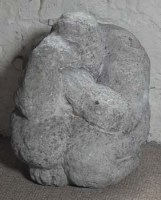 Lot 748 - Carved stone figure of a crouching man,   28cm
