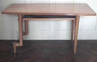 Lot 756 - 1950's walnut veneered shaped desk,   with