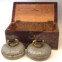 Lot 16 - Cased pair of curling stones.