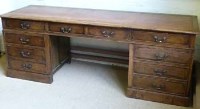 Lot 436 - Oak twin pedestal desk with inset leather top.