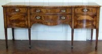 Lot 437 - Serpentine mahogany sideboard.