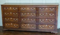 Lot 445 - George III oak twelve drawer dresser.