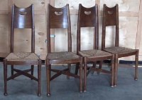 Lot 450 - Four Arts and Crafts oak and rush seated chairs