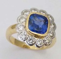 Lot 348 - Sapphire and diamond cushion cluster ring in 18ct