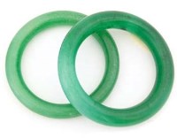 Lot 434 - Pair of green jade bangles.