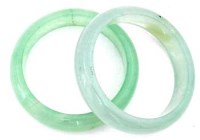 Lot 435 - Pair of pale green jade bangles.