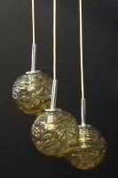 Lot 840 - 1970's embossed amber trio of hanging lights.