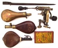 Lot 140 - Shotgun cartridge reloading tool and three powder flasks, gun powder tin and spring bayonet.