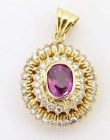 Lot 356 - Oval cluster diamond pendant set with a central