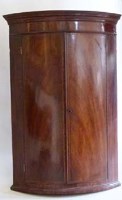 Lot 687 - Mahogany wall hanging bow-fronted corner cupboard early 19th century