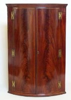 Lot 693 - George III mahogany corner cupboard.