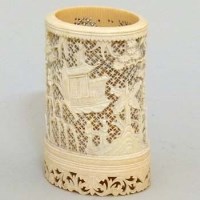 Lot 234 - Ivory tusk carved and pierced with oriental figures and pagodas